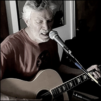 Jonathan Ochshorn with guitar performing Fast Car